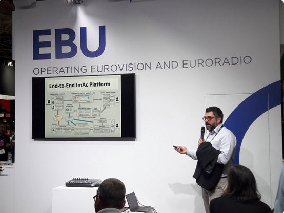 Image of the ImAc presentation on a stage at the EBU meet up